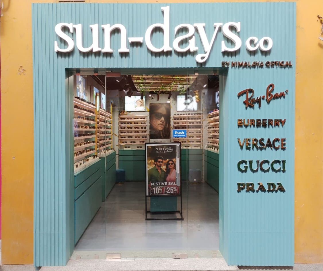 Storefront with 'sun-days co' branding and luxury brand names displayed.